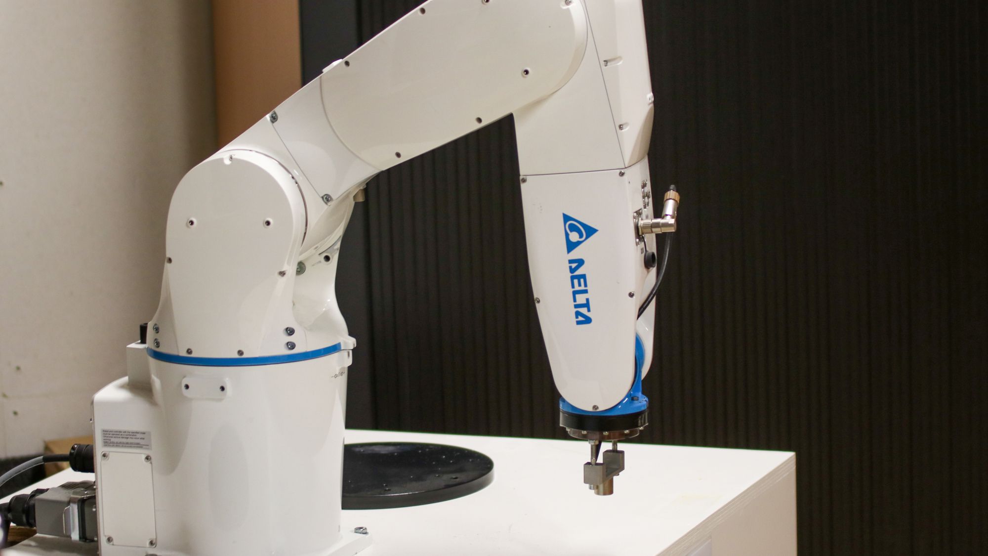 A single robotic arm on a stand, representing an autonomous agent